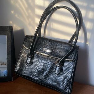 black leather purse with gold accents